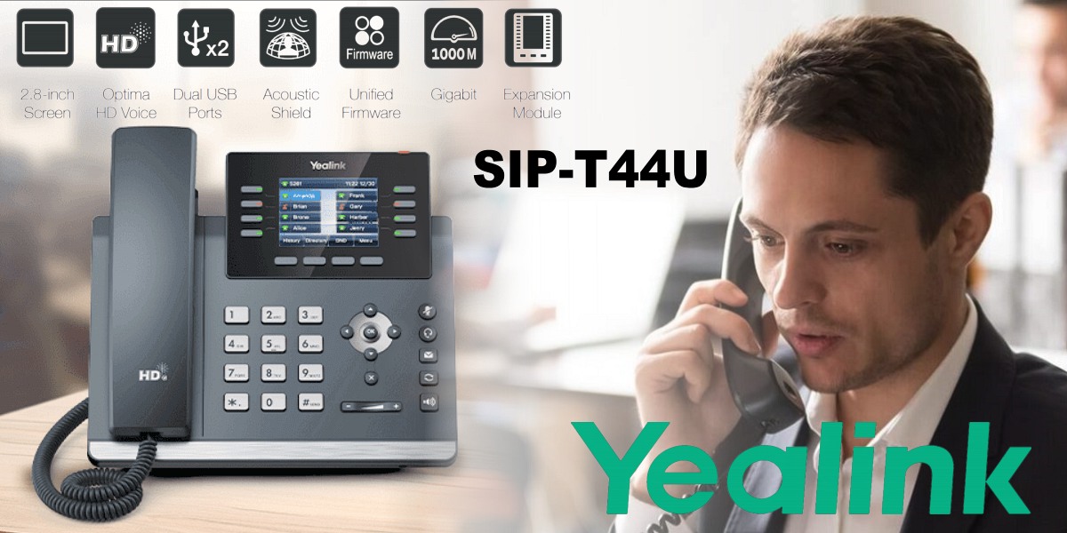  A man in business attire speaking on a Yealink SIP-T44U business telephone with highlighted features and the brand's logo visible.